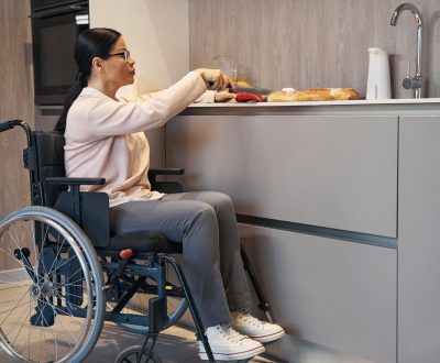 Mature woman with paraleria cooking in kitchen